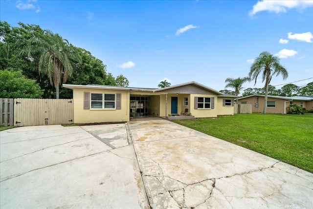 ranch-style house featuring a gate, driveway, and stucco siding