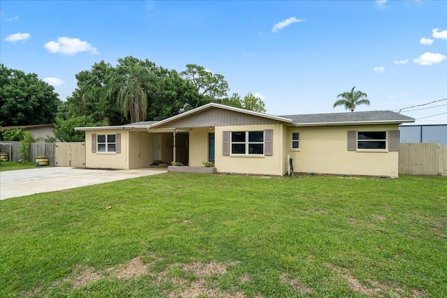 ranch-style home featuring stucco siding, concrete driveway, and a patio
