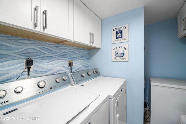 laundry room featuring cabinet space and separate washer and dryer