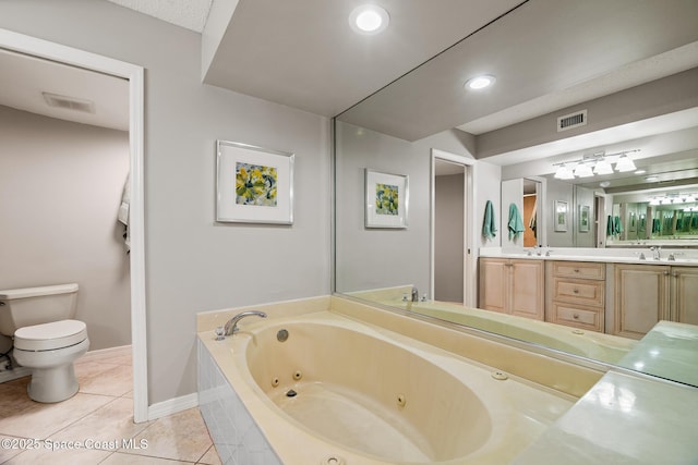 full bath with a jetted tub, toilet, tile patterned flooring, double vanity, and baseboards