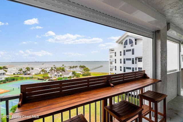 balcony featuring a water view