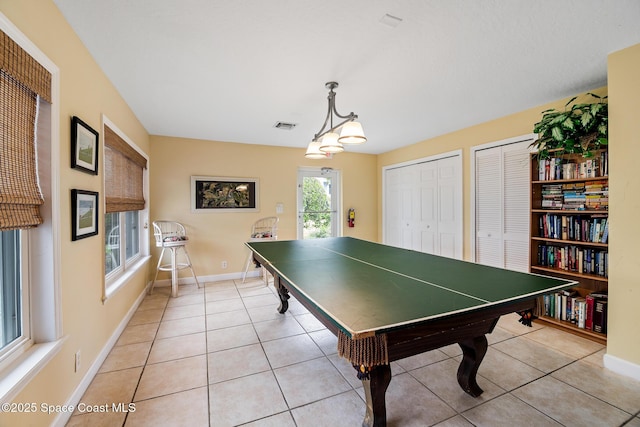 game room with light tile patterned floors and baseboards