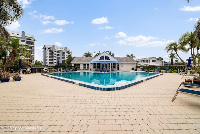 community pool featuring a patio area and fence