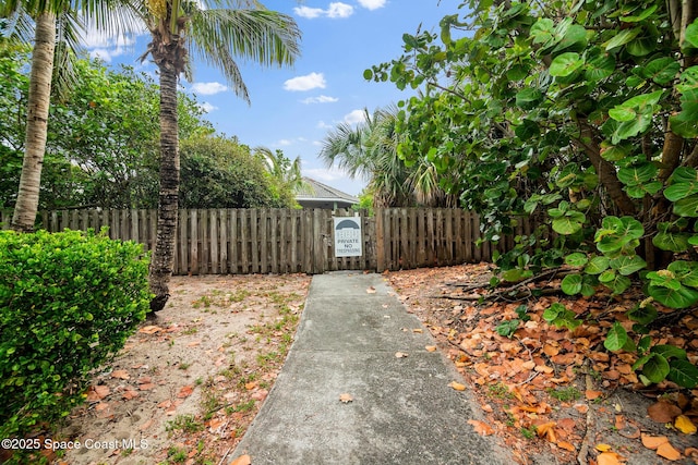 view of yard with fence and a gate