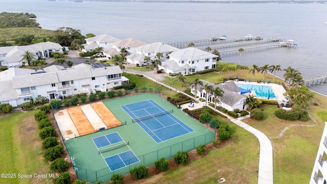 aerial perspective of suburban area with a nearby body of water and a pool area