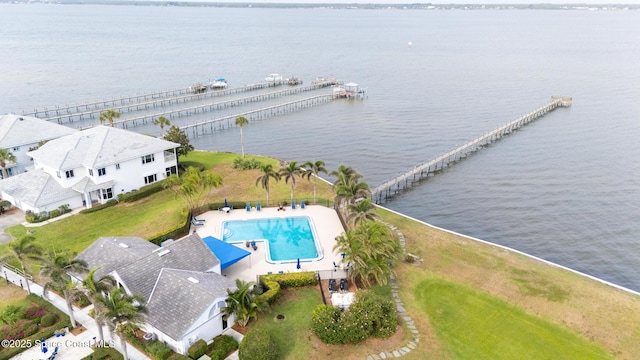 aerial view of a pool area and a nearby body of water