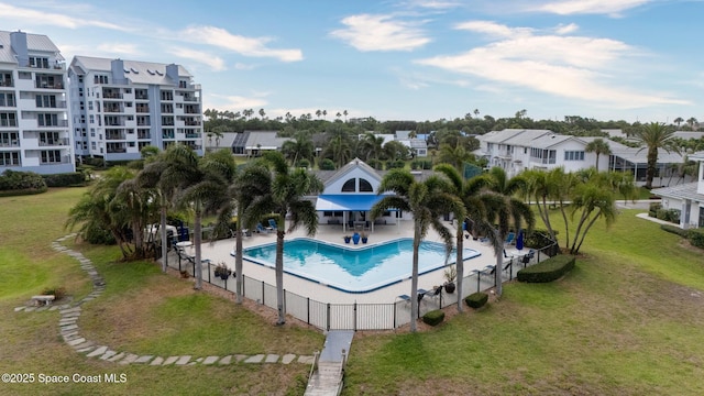 community pool with a patio and a residential view