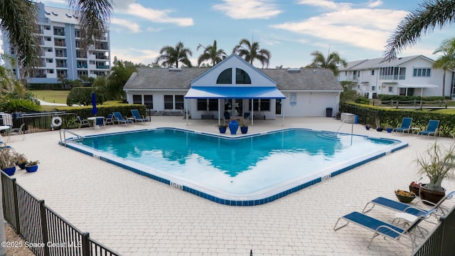 community pool featuring a patio and fence