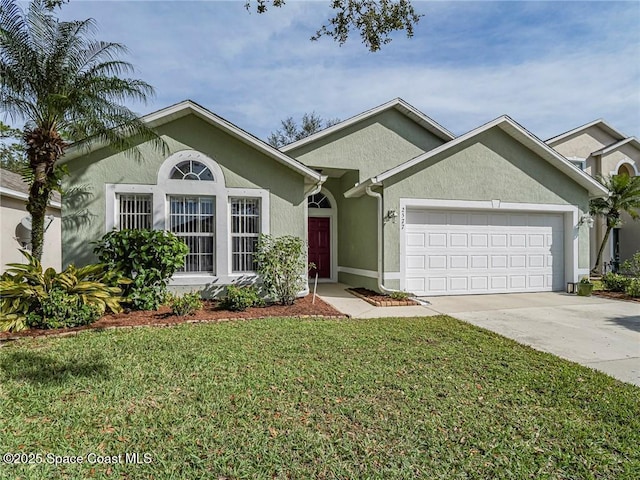 ranch-style house featuring stucco siding, a garage, driveway, and a front yard