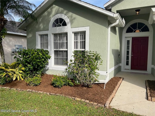 entrance to property with stucco siding