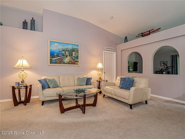 living area with vaulted ceiling, light carpet, and baseboards