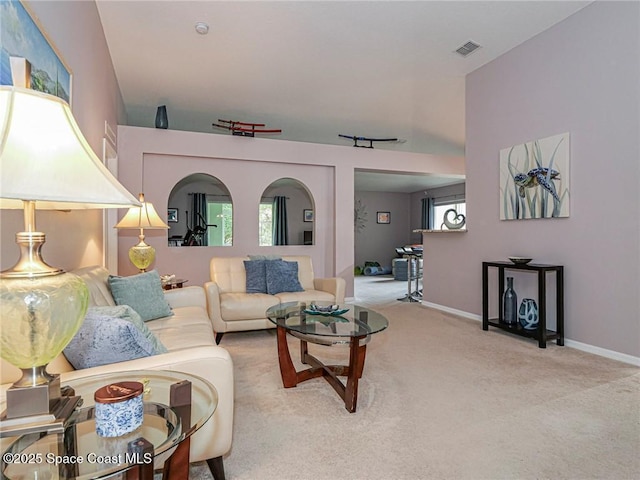 carpeted living room featuring baseboards