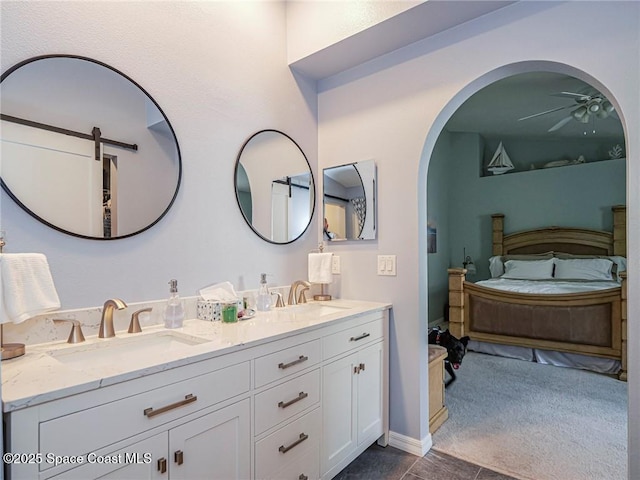 full bath with connected bathroom, ceiling fan, and double vanity