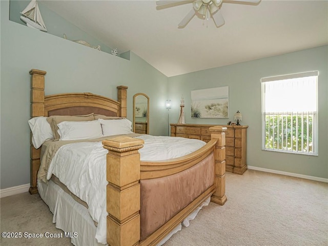 bedroom with baseboards, light carpet, lofted ceiling, and ceiling fan