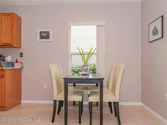 dining area with light tile patterned floors and baseboards