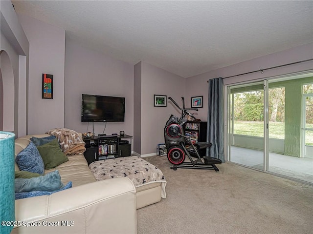 living room with carpet flooring, arched walkways, lofted ceiling, and baseboards