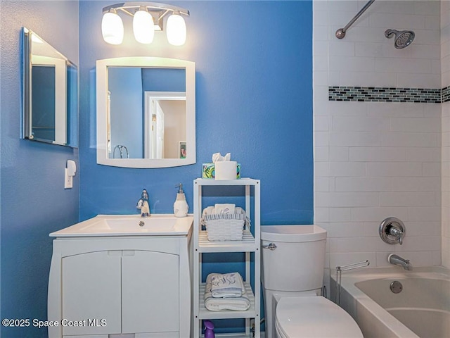 bathroom featuring tub / shower combination, toilet, and vanity