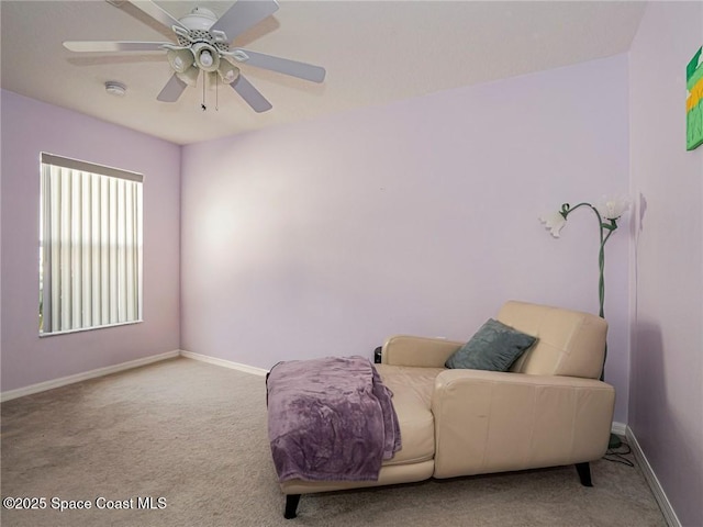 living area with carpet flooring, baseboards, and ceiling fan