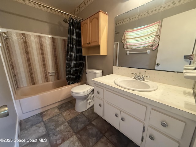 bathroom with shower / bath combo, toilet, vanity, and stone finish floors