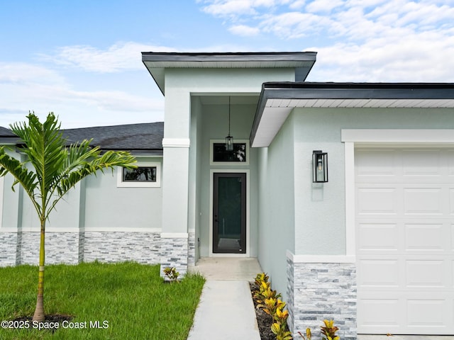 2990 Hackensack Ave SE, Palm Bay, FL 32909 - view of exterior entry with stone siding, stucco siding, and a garage