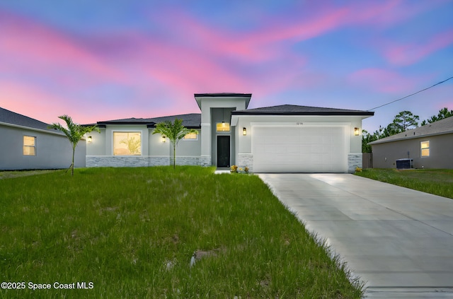 2990 Hackensack Ave SE, Palm Bay, FL 32909 - view of front of home with stone siding, a garage, stucco siding, driveway, and a front lawn