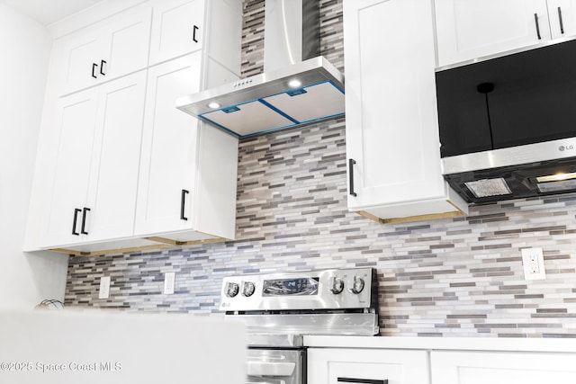 2990 Hackensack Ave SE, Palm Bay, FL 32909 - kitchen with wall chimney range hood, tasteful backsplash, white cabinetry, and light countertops