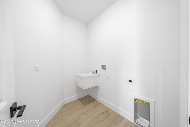 2990 Hackensack Ave SE, Palm Bay, FL 32909 - washroom featuring hookup for an electric dryer, light wood-style floors, and hookup for a washing machine