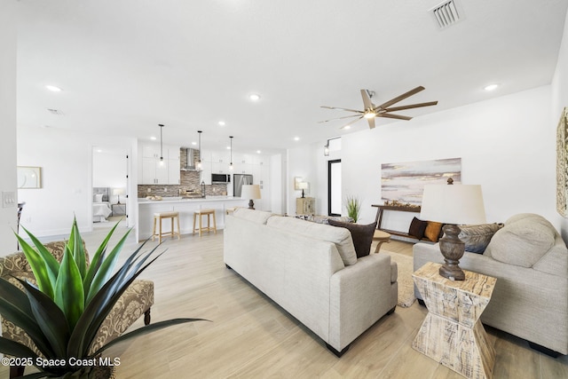 2990 Hackensack Ave SE, Palm Bay, FL 32909 - living area featuring ceiling fan, light wood-type flooring, and recessed lighting