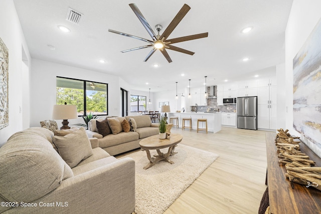 2990 Hackensack Ave SE, Palm Bay, FL 32909 - living room featuring ceiling fan, recessed lighting, and light wood-type flooring