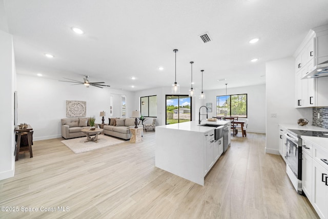 2990 Hackensack Ave SE, Palm Bay, FL 32909 - kitchen featuring stainless steel electric range, recessed lighting, light wood-type flooring, a ceiling fan, and light countertops