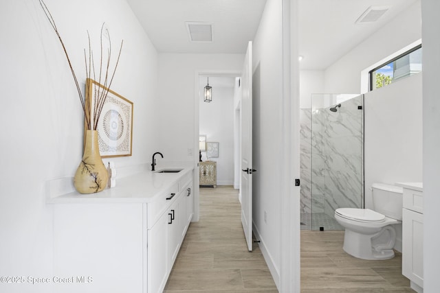 2990 Hackensack Ave SE, Palm Bay, FL 32909 - ensuite bathroom featuring vanity, a marble finish shower, and wood finished floors