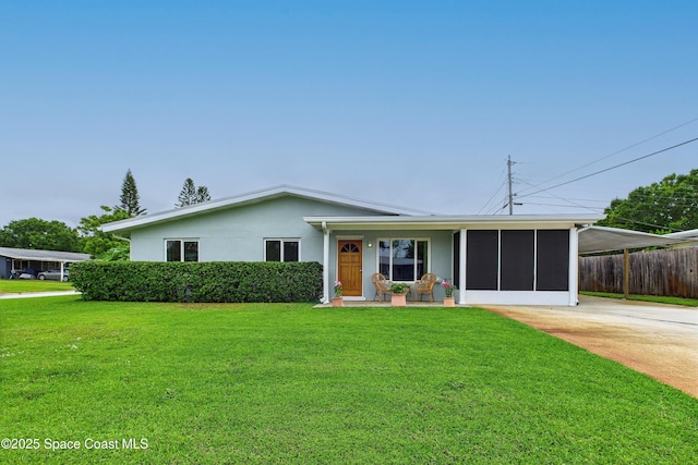 2341 Pawnee Dr, Melbourne, FL 32935 - view of front of property featuring a sunroom, stucco siding, and driveway