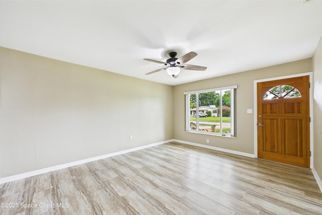 2341 Pawnee Dr, Melbourne, FL 32935 - foyer featuring light wood-style floors, ceiling fan, and baseboards