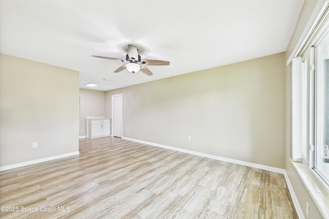 2341 Pawnee Dr, Melbourne, FL 32935 - spare room with ceiling fan, light wood-type flooring, plenty of natural light, and baseboards
