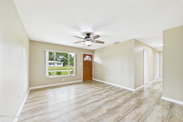 2341 Pawnee Dr, Melbourne, FL 32935 - foyer featuring ceiling fan, light wood-style floors, and baseboards