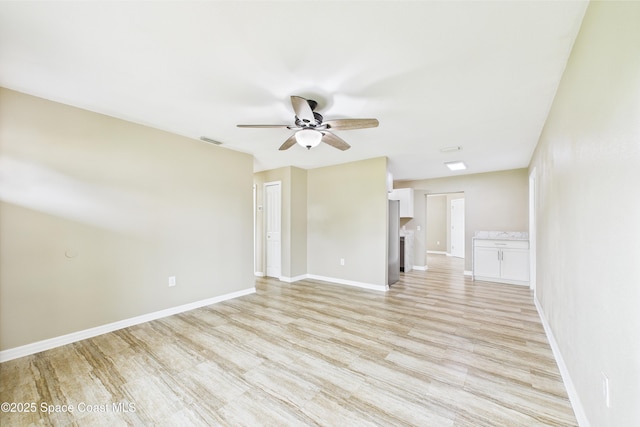 2341 Pawnee Dr, Melbourne, FL 32935 - unfurnished living room featuring ceiling fan, light wood-style flooring, and baseboards
