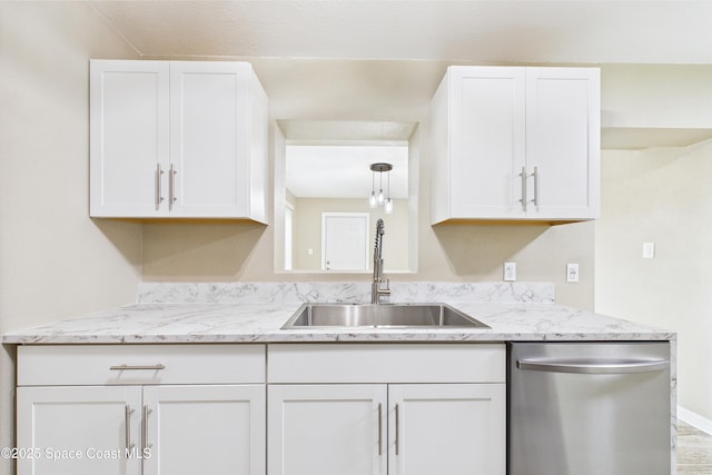 2341 Pawnee Dr, Melbourne, FL 32935 - kitchen with dishwasher, a sink, white cabinets, and light stone countertops