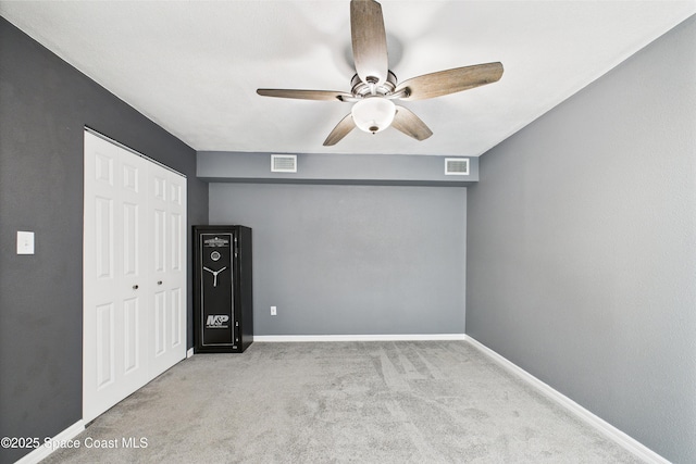 2341 Pawnee Dr, Melbourne, FL 32935 - unfurnished bedroom featuring a closet, carpet floors, baseboards, and ceiling fan