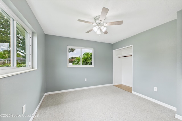 2341 Pawnee Dr, Melbourne, FL 32935 - unfurnished bedroom featuring multiple windows, carpet, and baseboards