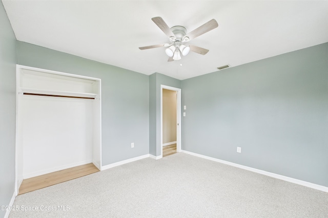 2341 Pawnee Dr, Melbourne, FL 32935 - unfurnished bedroom featuring carpet flooring, baseboards, a closet, and a ceiling fan