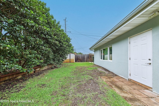 2341 Pawnee Dr, Melbourne, FL 32935 - view of yard featuring a storage shed and an outbuilding