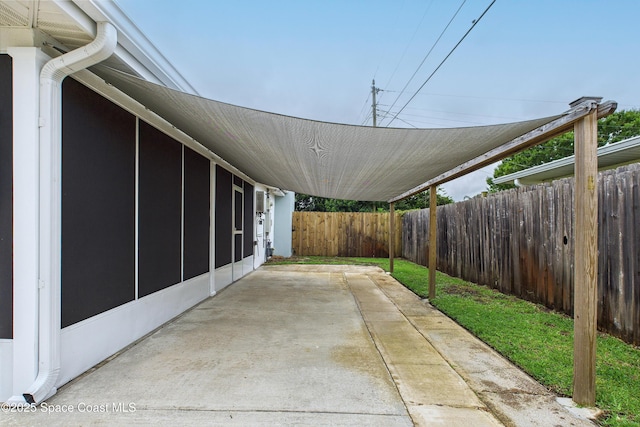2341 Pawnee Dr, Melbourne, FL 32935 - view of patio with a fenced backyard and a carport