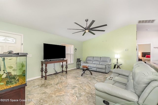 living area featuring vaulted ceiling, ceiling fan, baseboards, and light stone finish flooring