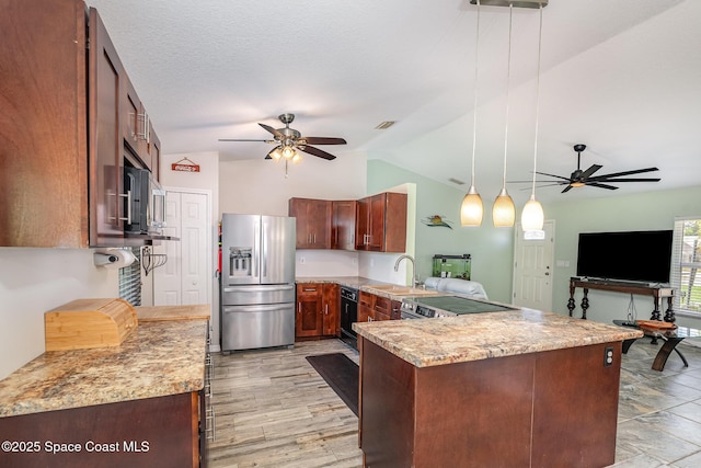 kitchen featuring appliances with stainless steel finishes, ceiling fan, a sink, lofted ceiling, and a peninsula