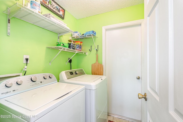clothes washing area with independent washer and dryer and a textured ceiling