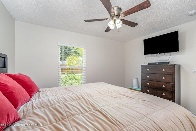 bedroom featuring a textured ceiling and a ceiling fan
