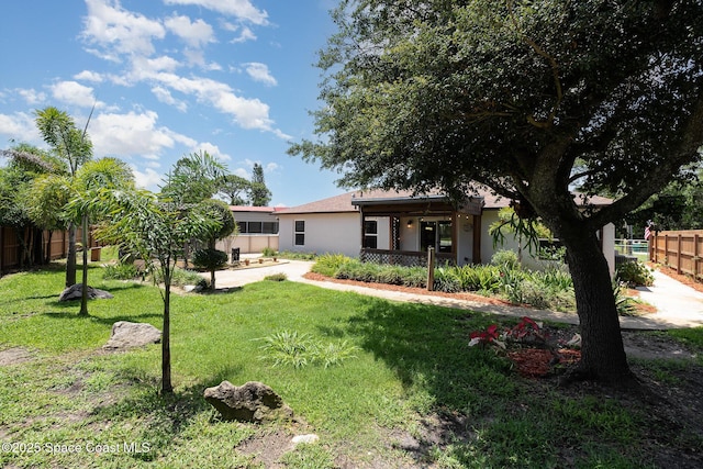 rear view of property featuring stucco siding