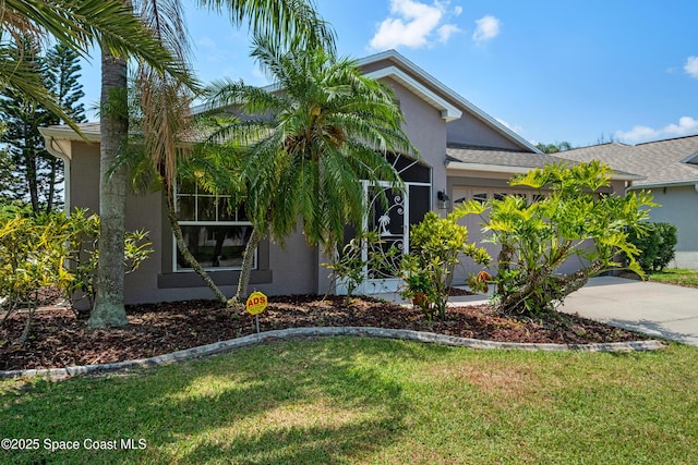 2127 Deercroft Dr, Melbourne, FL 32940 - view of front of property featuring stucco siding, a garage, a front yard, and concrete driveway
