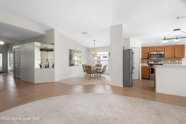 2127 Deercroft Dr, Melbourne, FL 32940 - kitchen featuring stainless steel appliances, light tile patterned floors, brown cabinets, light countertops, and baseboards