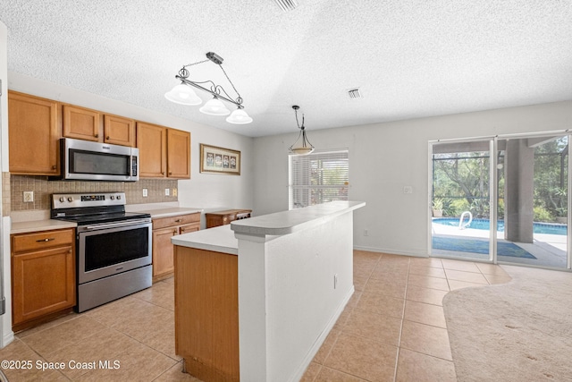 2127 Deercroft Dr, Melbourne, FL 32940 - kitchen featuring appliances with stainless steel finishes, light tile patterned floors, a textured ceiling, backsplash, and light countertops